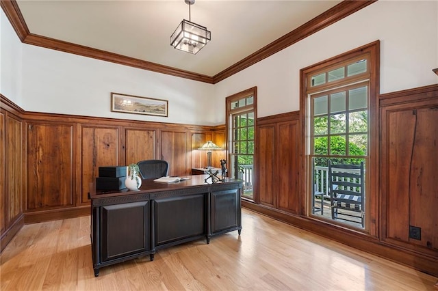 office area featuring light wood finished floors, ornamental molding, and wainscoting