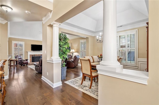foyer entrance featuring decorative columns and hardwood / wood-style floors