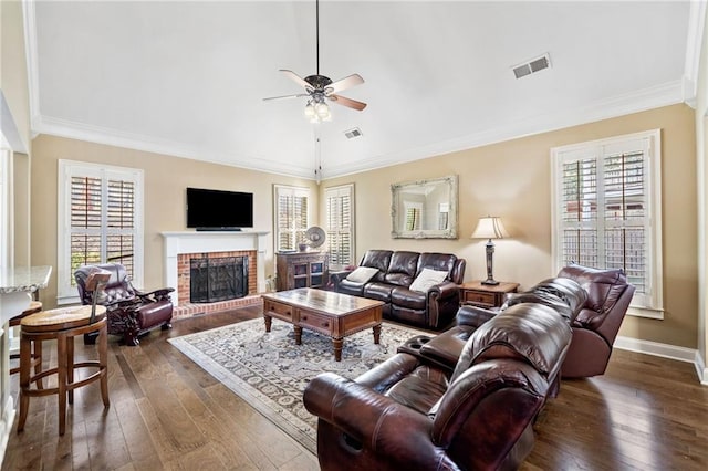 living area featuring a fireplace, dark wood-style flooring, ceiling fan, and visible vents