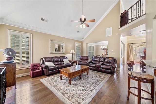 living area featuring crown molding, dark wood-style floors, visible vents, and ceiling fan with notable chandelier