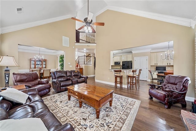 living area featuring dark wood-style flooring, visible vents, crown molding, baseboards, and ceiling fan with notable chandelier
