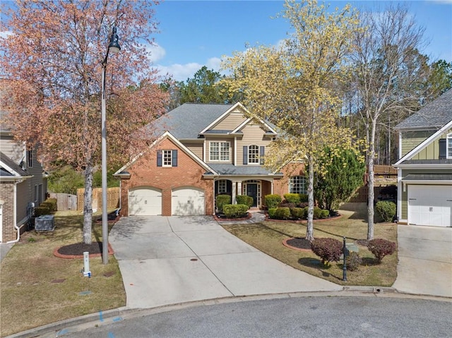 traditional home with fence, driveway, central AC unit, a front yard, and brick siding