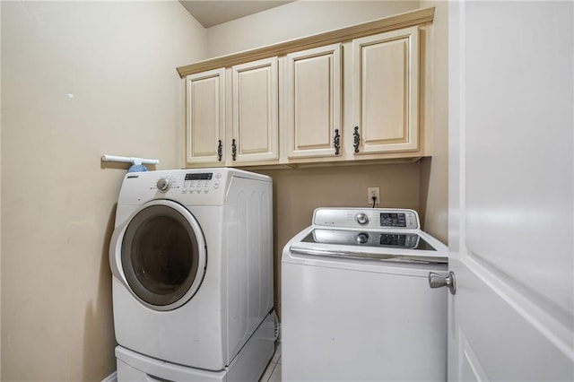 laundry area with cabinet space and separate washer and dryer