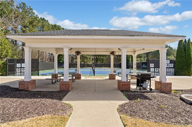 view of property's community with fence and a gazebo