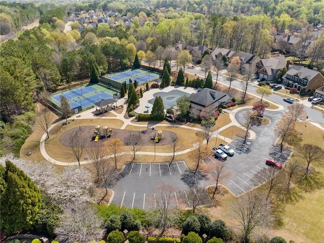 drone / aerial view featuring a wooded view