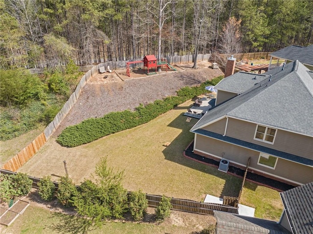drone / aerial view with a wooded view