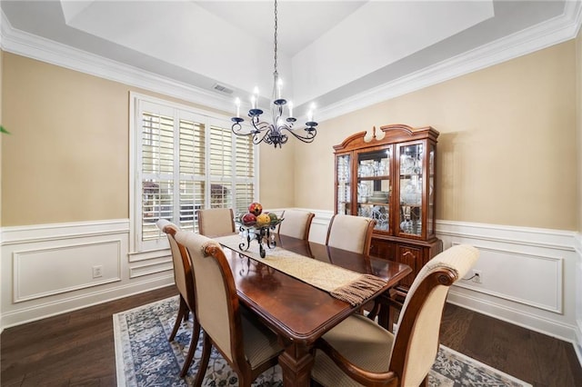 dining room featuring dark wood-style flooring, visible vents, a notable chandelier, and wainscoting