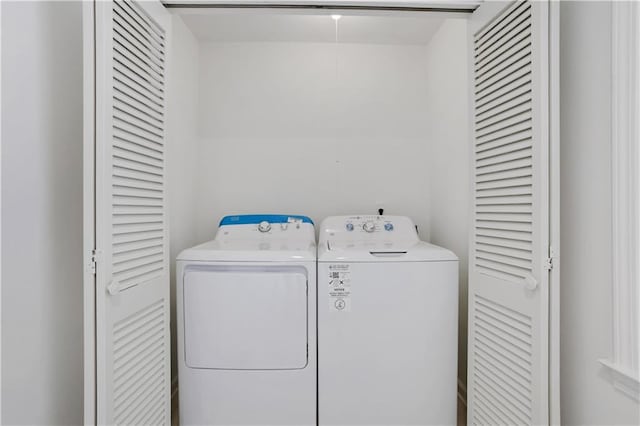 clothes washing area with laundry area and separate washer and dryer