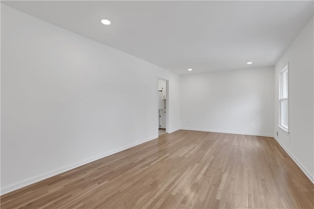 unfurnished room featuring light wood-style floors, baseboards, and recessed lighting