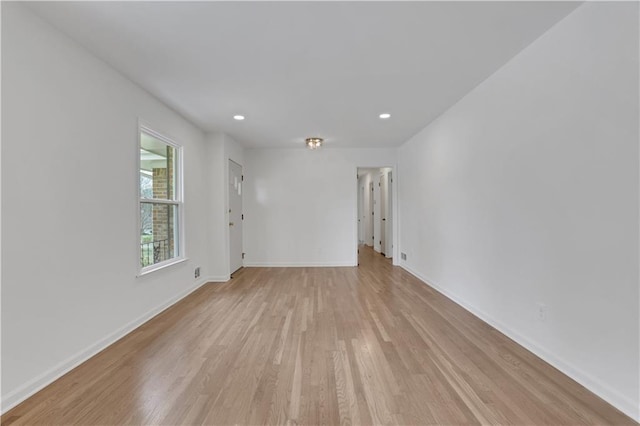 spare room featuring recessed lighting, baseboards, and light wood finished floors