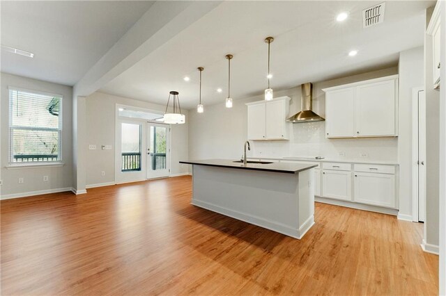 20 Running Ter NW, Cartersville, GA 30121 - kitchen with a sink, light wood finished floors, visible vents, wall chimney range hood, and white cabinets