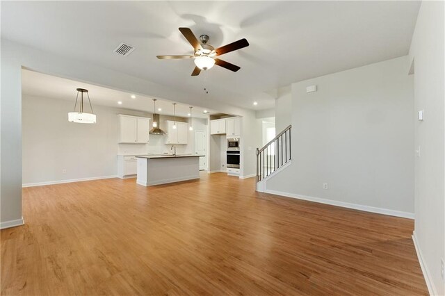20 Running Ter NW, Cartersville, GA 30121 - unfurnished living room featuring baseboards, light wood-style flooring, ceiling fan, and visible vents