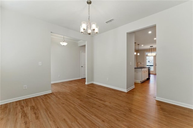 20 Running Ter NW, Cartersville, GA 30121 - spare room with visible vents, a chandelier, light wood finished floors, baseboards, and a sink
