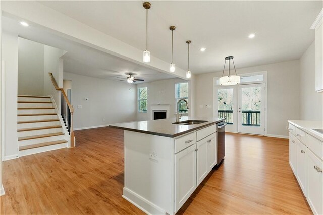 20 Running Ter NW, Cartersville, GA 30121 - kitchen featuring a sink, a ceiling fan, a fireplace, open floor plan, and light wood-style floors