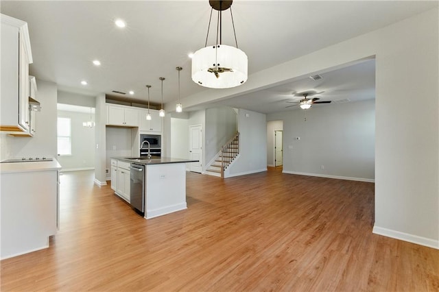 20 Running Ter NW, Cartersville, GA 30121 - kitchen featuring stainless steel appliances, a center island with sink, a sink, light wood-style floors, and white cabinets