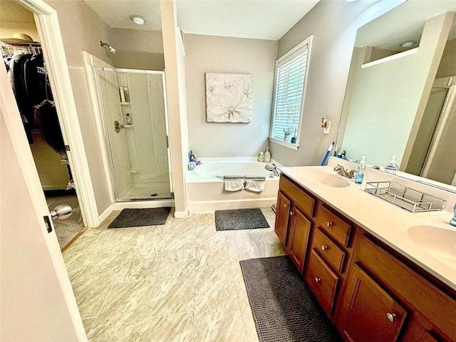 bathroom with separate shower and tub and vanity