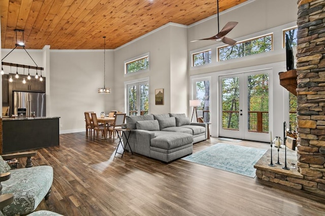 living room with wooden ceiling, ornamental molding, and french doors