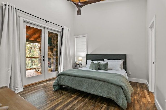 bedroom with ceiling fan, access to exterior, and dark wood-type flooring