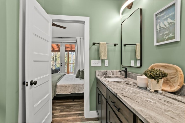 bathroom featuring vanity, wood-type flooring, and french doors