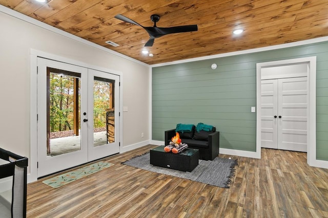 living area featuring hardwood / wood-style floors, ceiling fan, wooden ceiling, and french doors