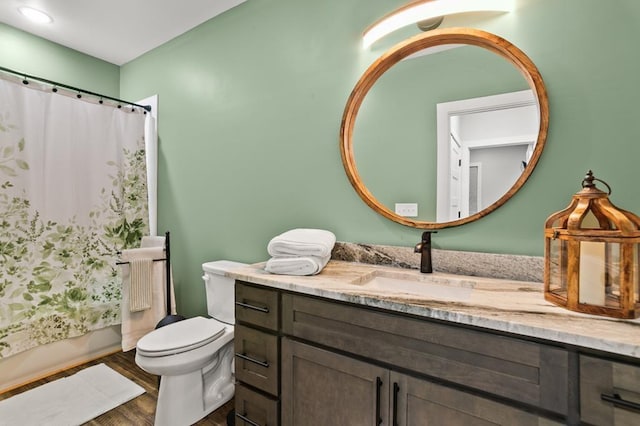 full bathroom with shower / bath combination with curtain, vanity, wood-type flooring, and toilet