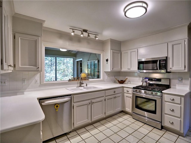 kitchen featuring sink, decorative backsplash, white cabinets, and appliances with stainless steel finishes