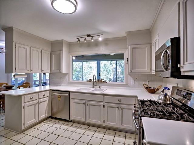 kitchen featuring white cabinetry, appliances with stainless steel finishes, kitchen peninsula, and sink