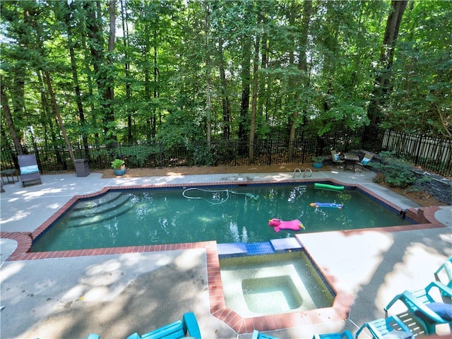 view of pool with an in ground hot tub and a patio area