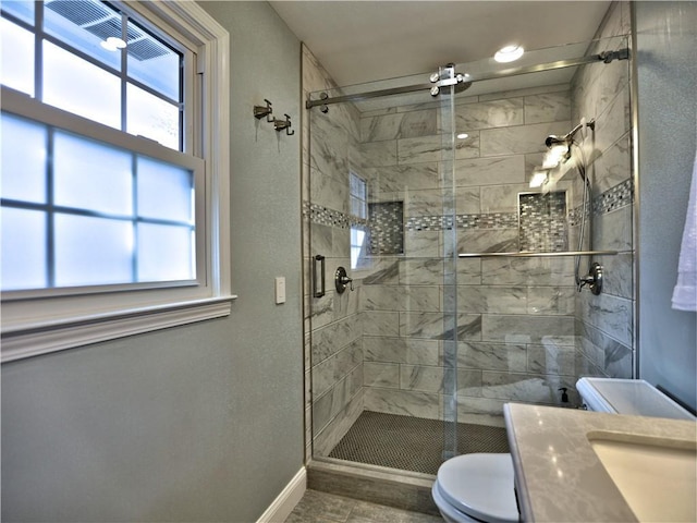 bathroom with toilet, an enclosed shower, and sink