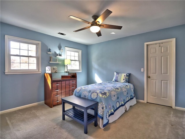 bedroom featuring light colored carpet and ceiling fan