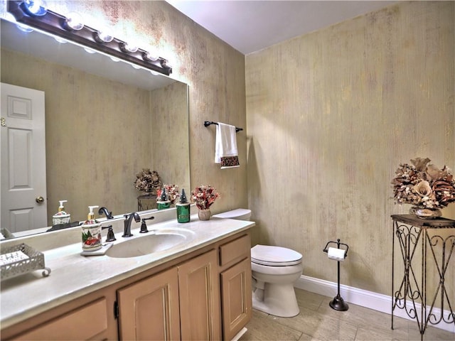 bathroom with vanity, toilet, and tile patterned flooring