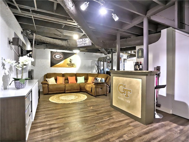 basement featuring bar and dark wood-type flooring