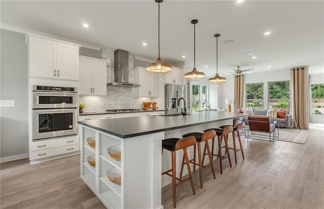 1088 Battery Park Rd, Decatur, GA 30033 - kitchen with wall chimney range hood, stainless steel appliances, a sink, dark countertops, and white cabinetry