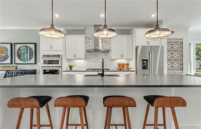 1088 Battery Park Rd, Decatur, GA 30033 - kitchen featuring appliances with stainless steel finishes, crown molding, decorative backsplash, white cabinets, and a breakfast bar area