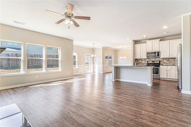 kitchen with ornamental molding, visible vents, open floor plan, dark wood-style floors, and appliances with stainless steel finishes