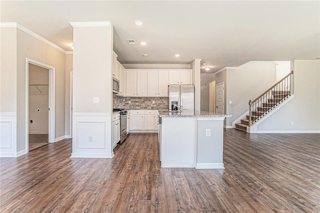 kitchen featuring white cabinetry, open floor plan, appliances with stainless steel finishes, and dark wood-type flooring