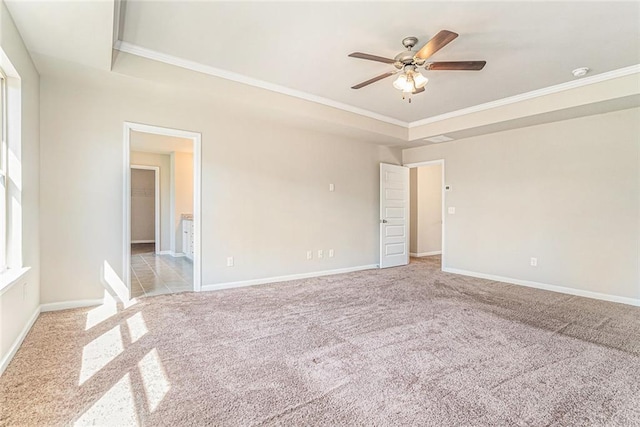 unfurnished room with carpet flooring, crown molding, baseboards, and ceiling fan