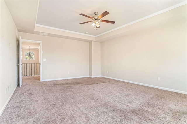 empty room featuring carpet floors, crown molding, visible vents, baseboards, and ceiling fan