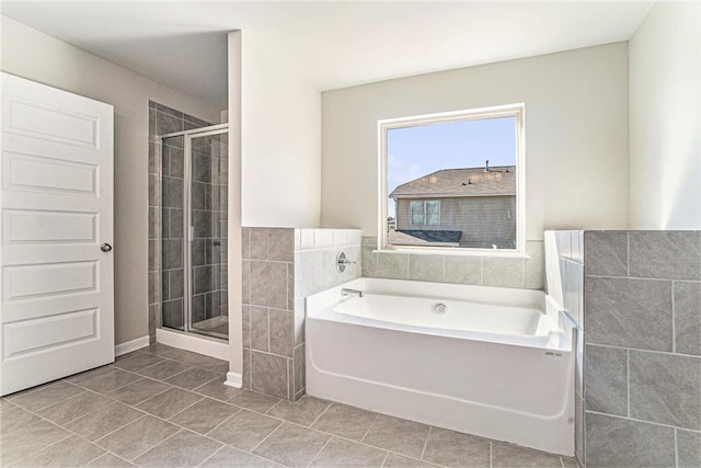 full bath with tile patterned flooring, tile walls, a garden tub, and a shower stall