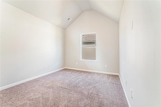 unfurnished room featuring lofted ceiling, carpet flooring, visible vents, and baseboards