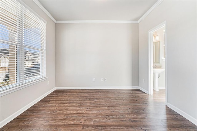 unfurnished room featuring ornamental molding, baseboards, and dark wood-style floors