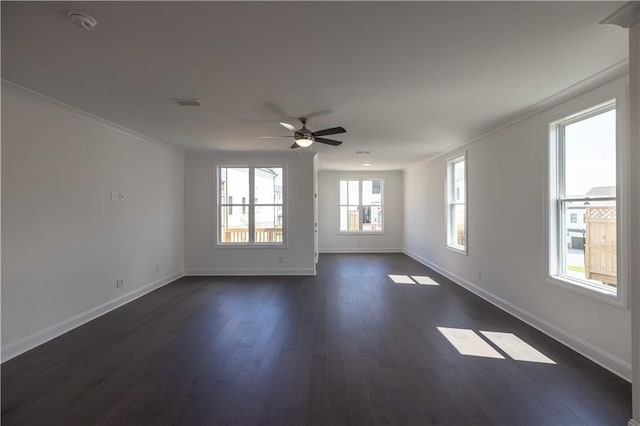 spare room featuring ceiling fan, dark wood-type flooring, and crown molding