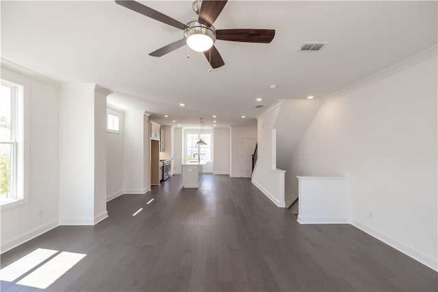 unfurnished living room with ceiling fan, dark hardwood / wood-style floors, and ornamental molding