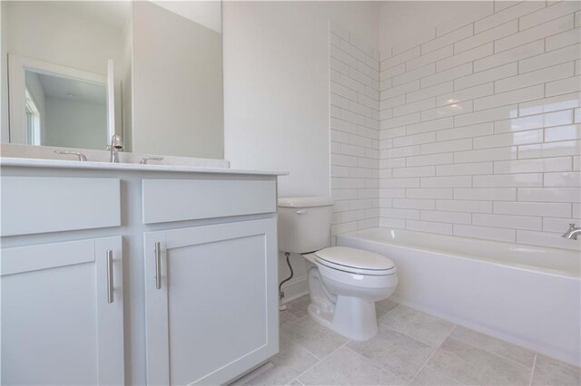 full bathroom with toilet, tiled shower / bath, and vanity