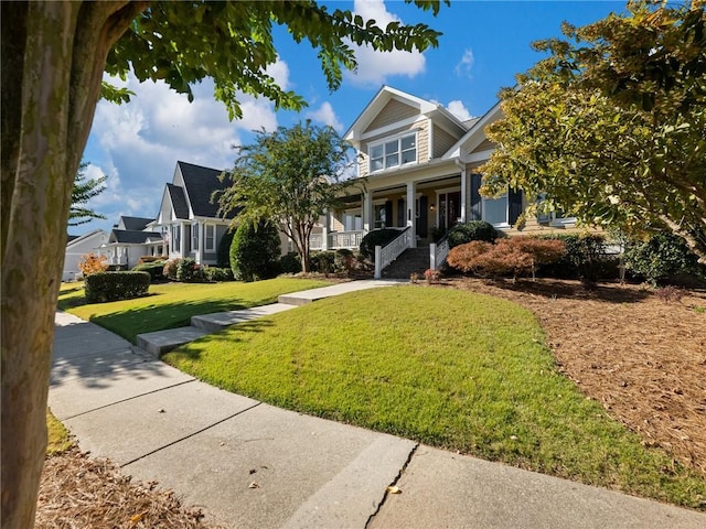 view of front of home with a porch and a front yard