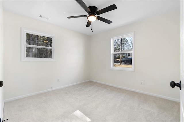 carpeted spare room with ceiling fan