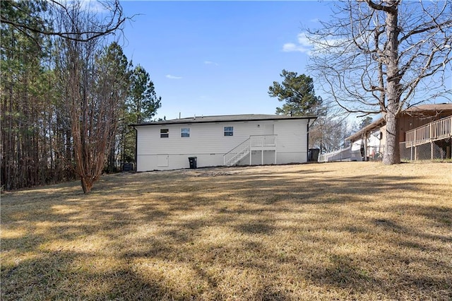 rear view of property with a lawn