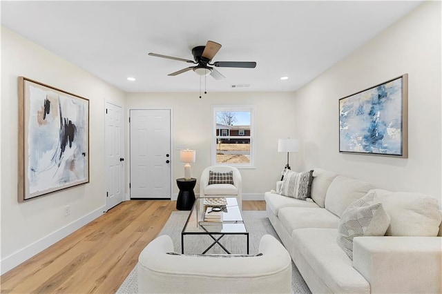 living room with ceiling fan and light hardwood / wood-style floors