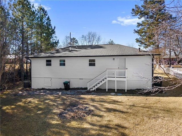 back of house with central AC and a yard