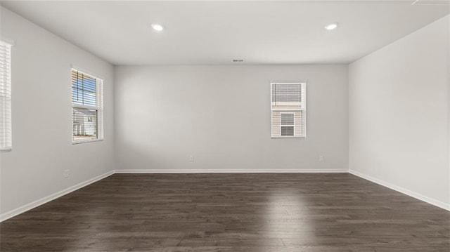 spare room with dark wood-type flooring